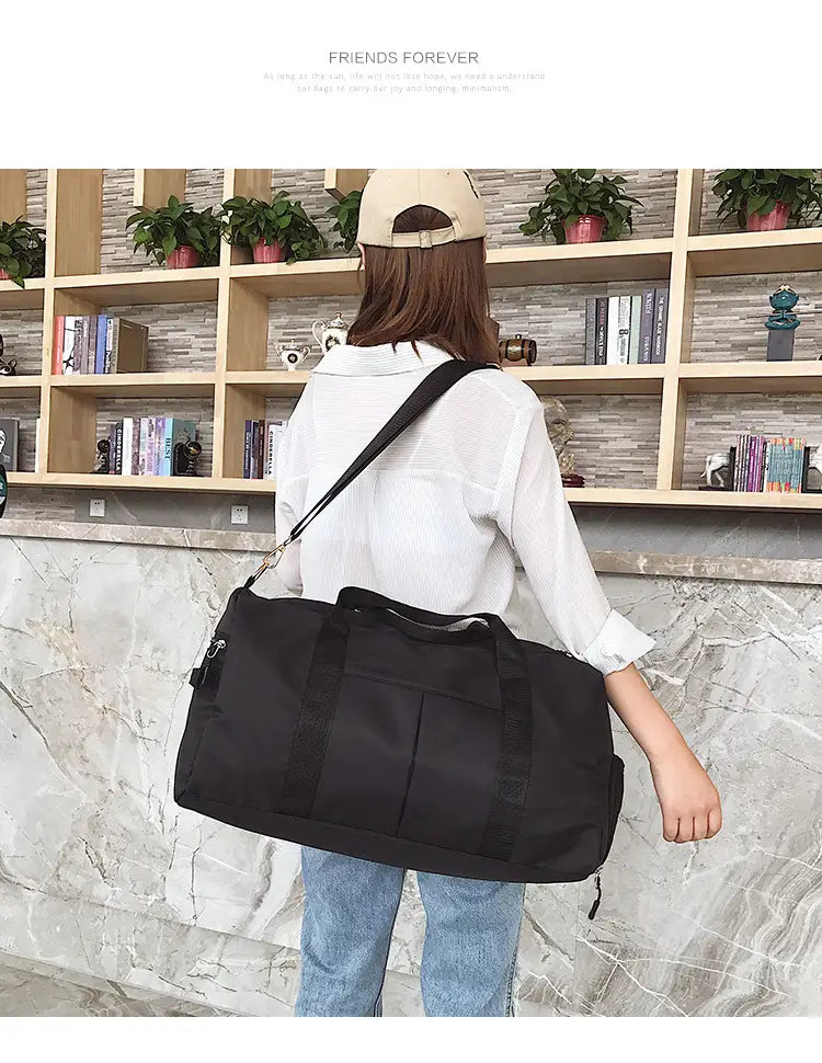 Black nylon duffel bag with adjustable shoulder strap and front zippered pocket from the rose gold nylon waterproof sports duffel bag collection.