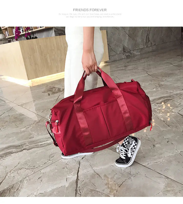 Red nylon sports duffel bag with reinforced handles and side pockets from the rose gold nylon waterproof collection.
