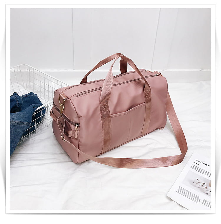 A soft rose gold nylon waterproof sports duffel bag with a sleek minimalist design and sturdy fabric straps.
