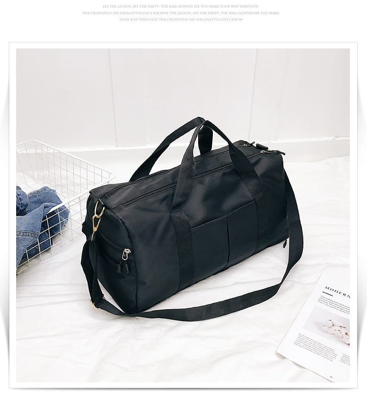 Black nylon duffel bag with gold-tone zippers and handles featured in the rose gold nylon waterproof sports duffel bag collection.