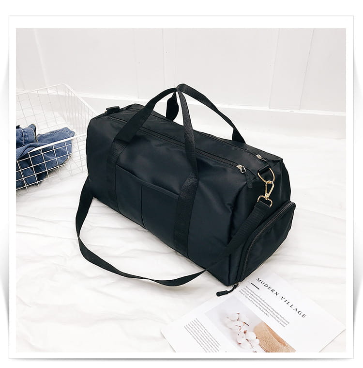 Black nylon duffel bag with dual top handles and a detachable shoulder strap designed as a rose gold nylon waterproof sports duffel bag.