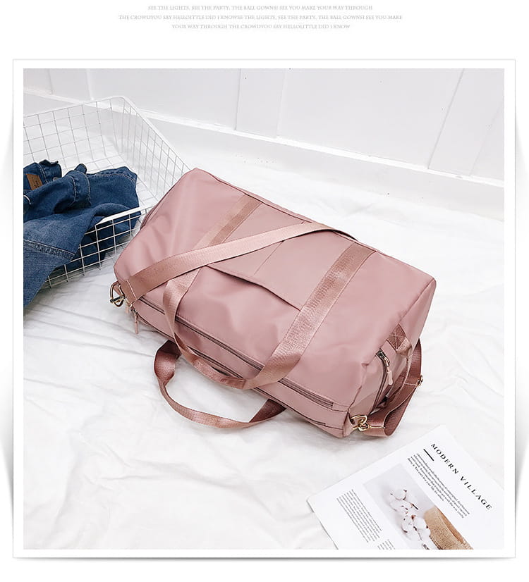 A soft rose gold nylon waterproof sports duffel bag with matching straps and zippers.