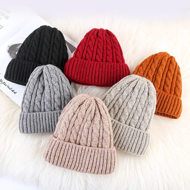 Cable knit beanie hats in black red orange gray and beige with fleece lining for winter warmth.