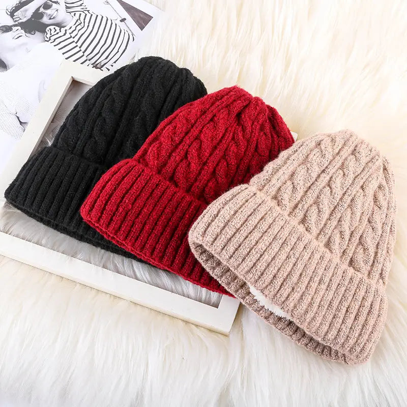 three fleece lined cable knit beanie hats in black, red, and beige for winter warmth and comfort