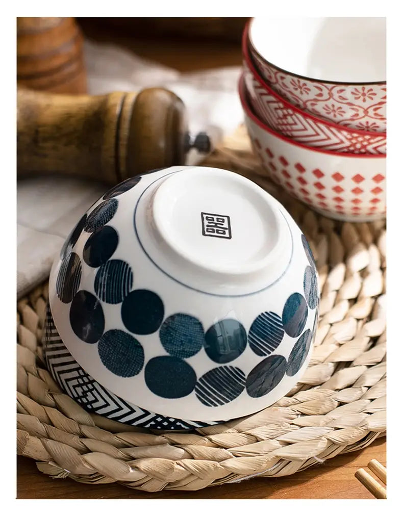 white ceramic bowl with navy blue circular patterns and black geometric accents from a ceramic bowl set 5 piece japanese floral porcelain collection.