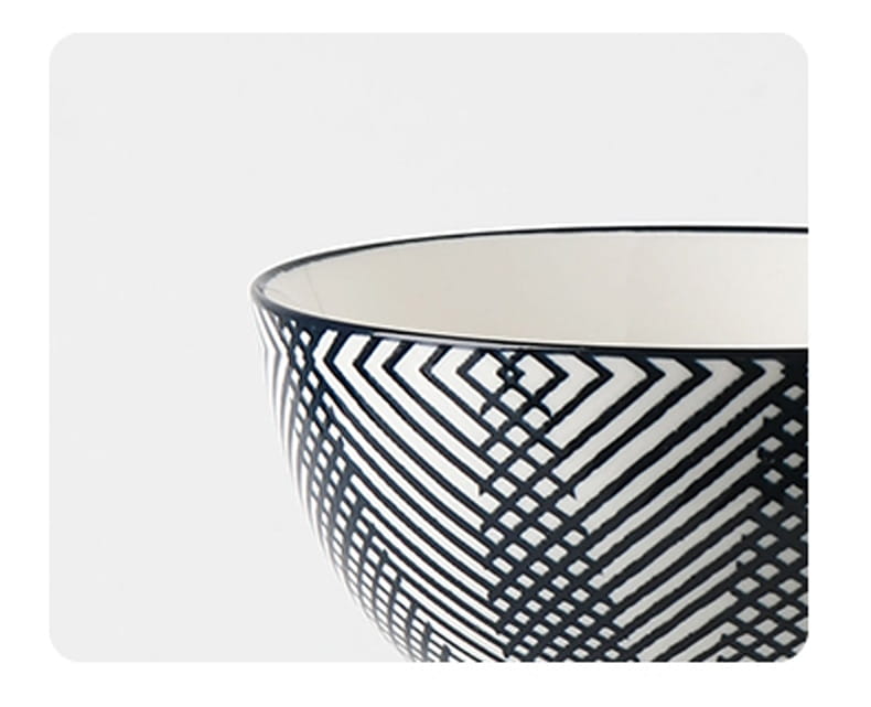 A black and white geometric patterned ceramic bowl with a glossy finish from a ceramic bowl set 5 piece Japanese floral porcelain.