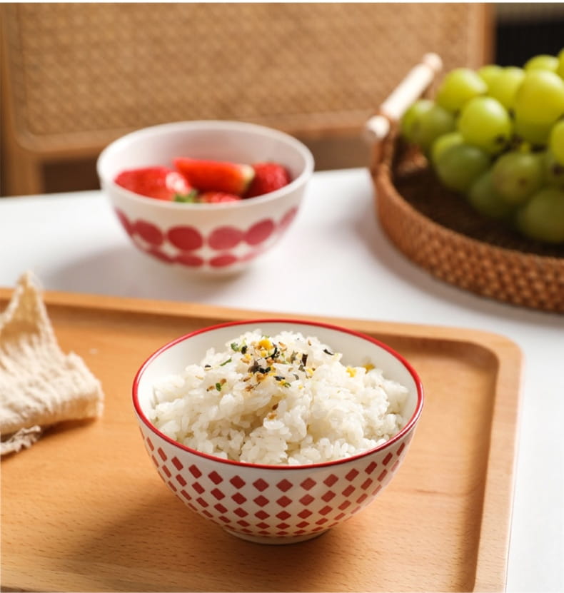 white ceramic bowl with red diamond pattern and rim filled with rice topped with sesame seeds from ceramic bowl set 5 piece japanese floral porcelain