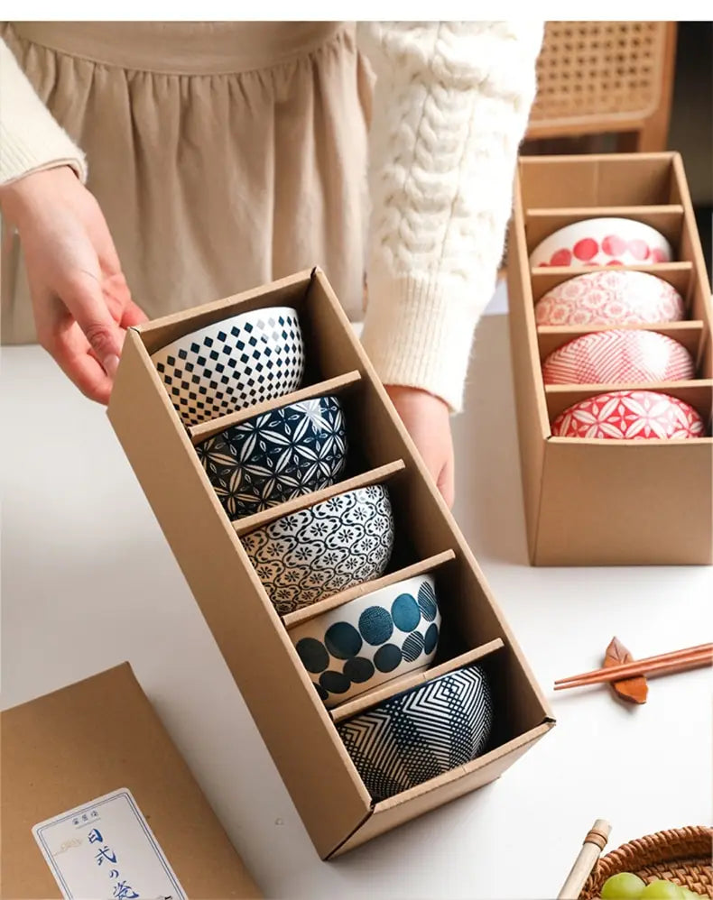 Set of five ceramic bowls in black and white with geometric patterns including checkers, stars, circles, and stripes made from Japanese floral porcelain.