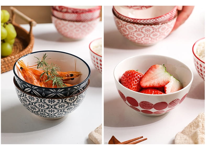 A set of five ceramic bowls featuring intricate black and white floral porcelain patterns with one bowl displaying a bold red circular design on its exterior.