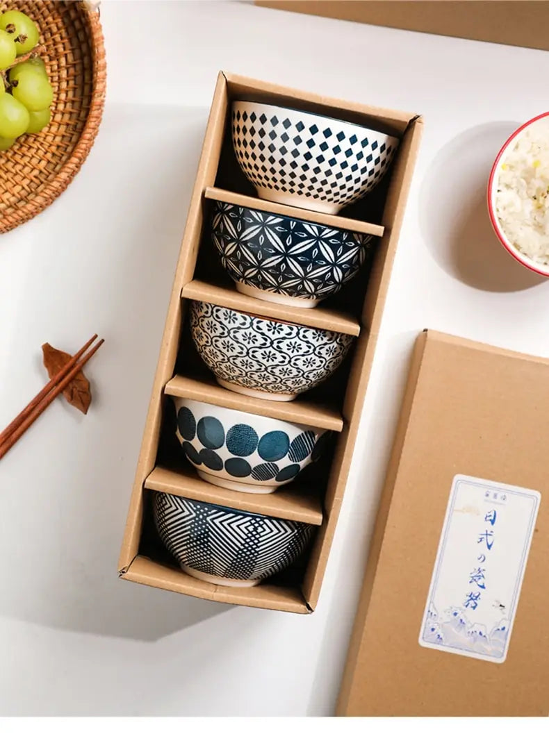Set of five ceramic bowls featuring unique black and white geometric patterns including diamonds floral motifs and circular shapes in Japanese floral porcelain.