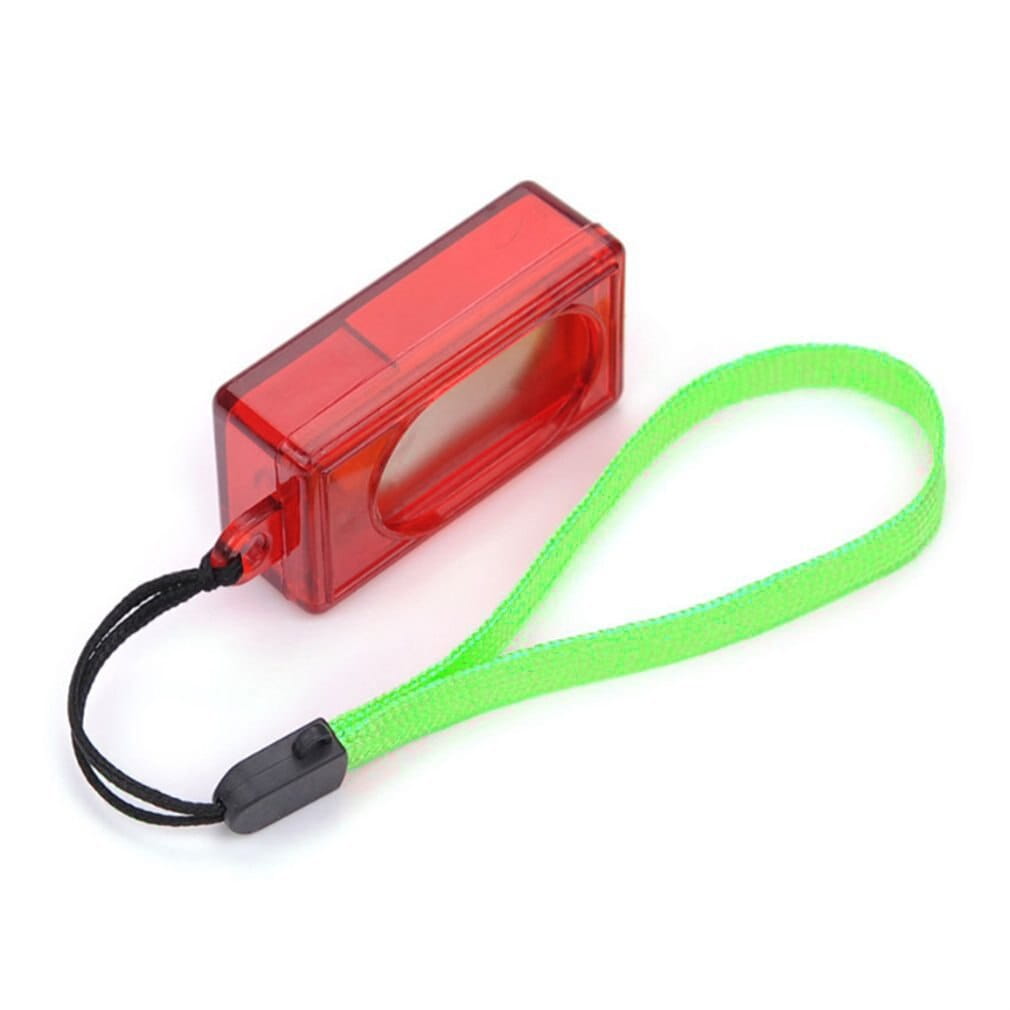 Red translucent rectangular dog training clicker with a bright green wrist strap and black cord attachment for effective pet training.