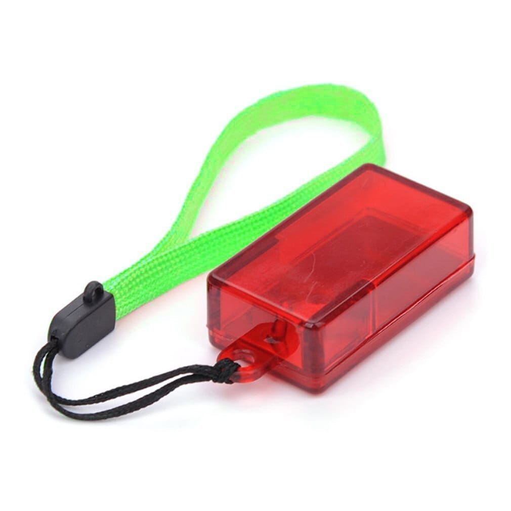 Red translucent rectangular led dog training clicker with a bright green wrist strap and black cord attachment for pet training use.