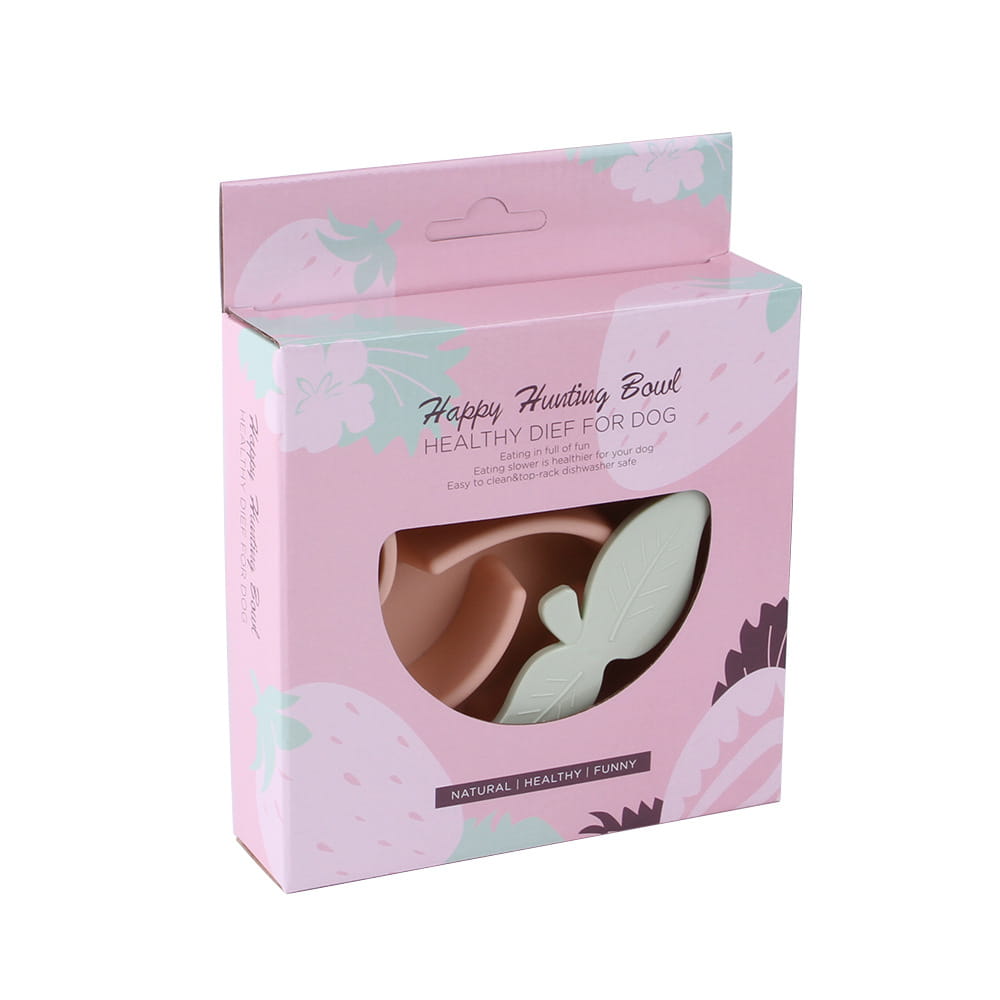 Caja con patrón floral en tonos rosa y menta que contiene un cuenco para perros de alimentación lenta de silicona con forma de hoja, elaborado en plástico para alimentar a las mascotas