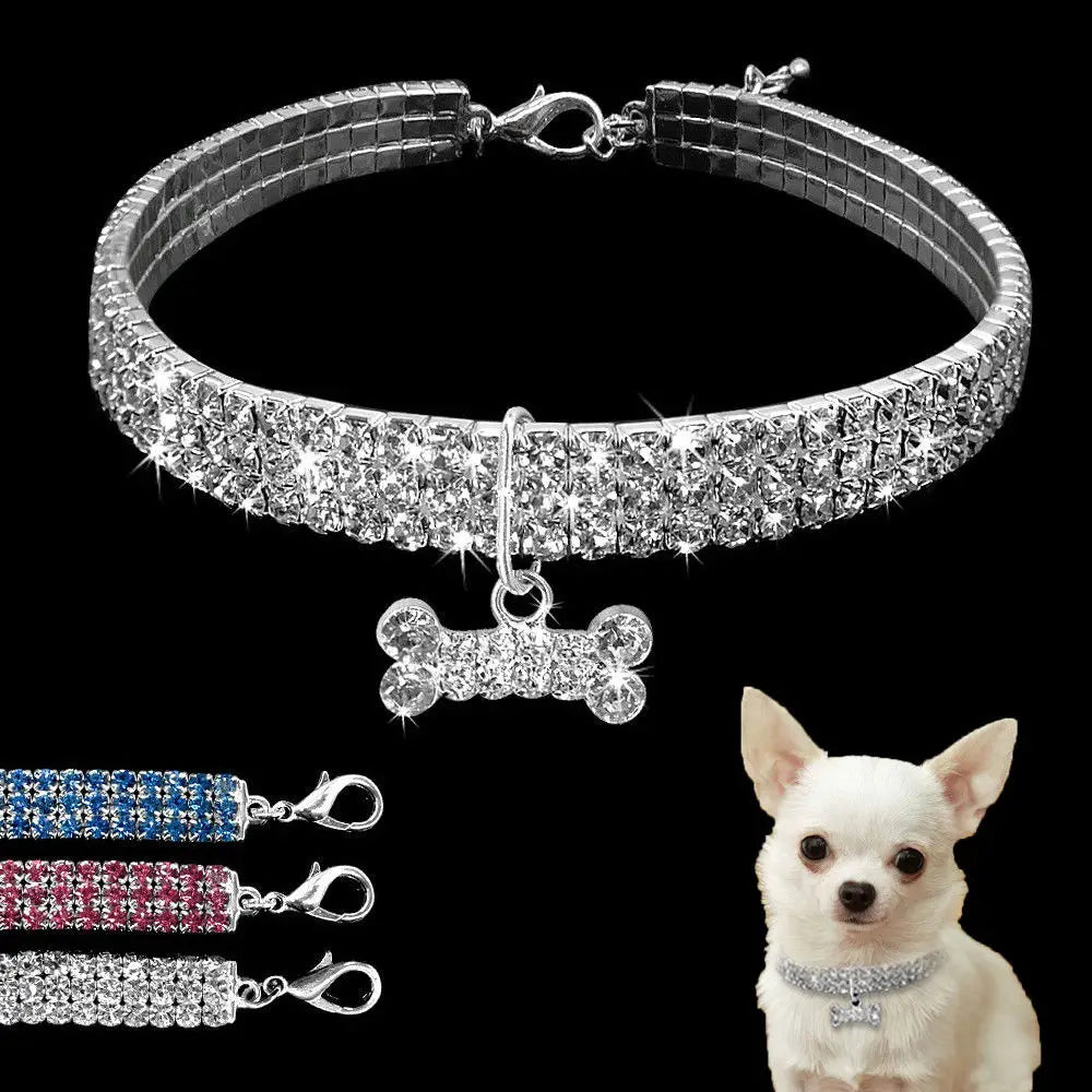 Silver rhinestone dog collar featuring a sparkling crystal bone-shaped pendant for stylish pet accessory use.