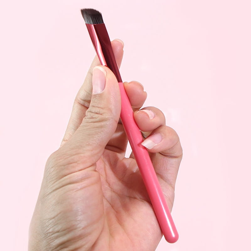 Wild eyebrow brush 3d stereoscopic makeup tool featuring a pink and metallic red angled handle with dense dark bristles designed for precise eyebrow application.