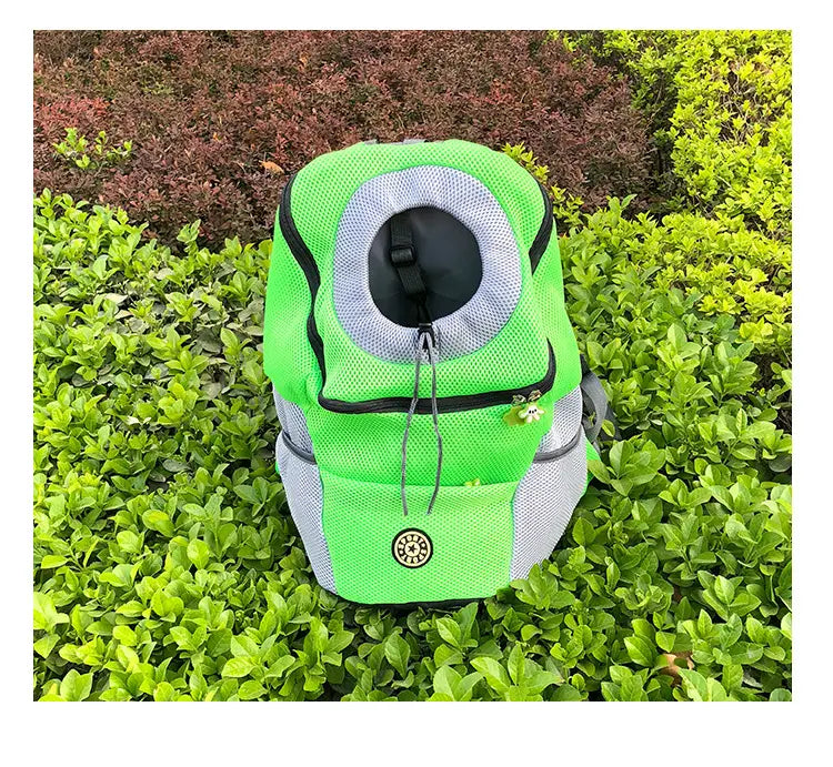 Bright green and gray breathable mesh pet carrier backpack with a circular opening for the animal’s head black trim and a small embroidered logo on the front.