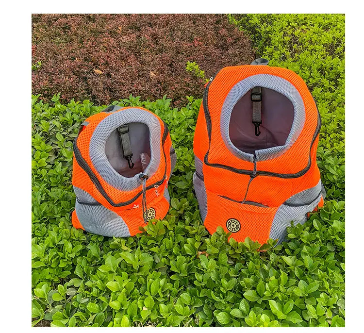 Bright orange and gray breathable mesh pet carrier backpack with adjustable straps and a circular logo on the front.