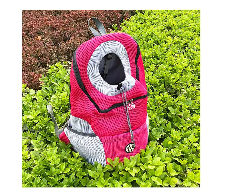 Breathable mesh pet carrier backpack in pink and gray mesh with a circular opening black trim and decorative floral zipper pull.