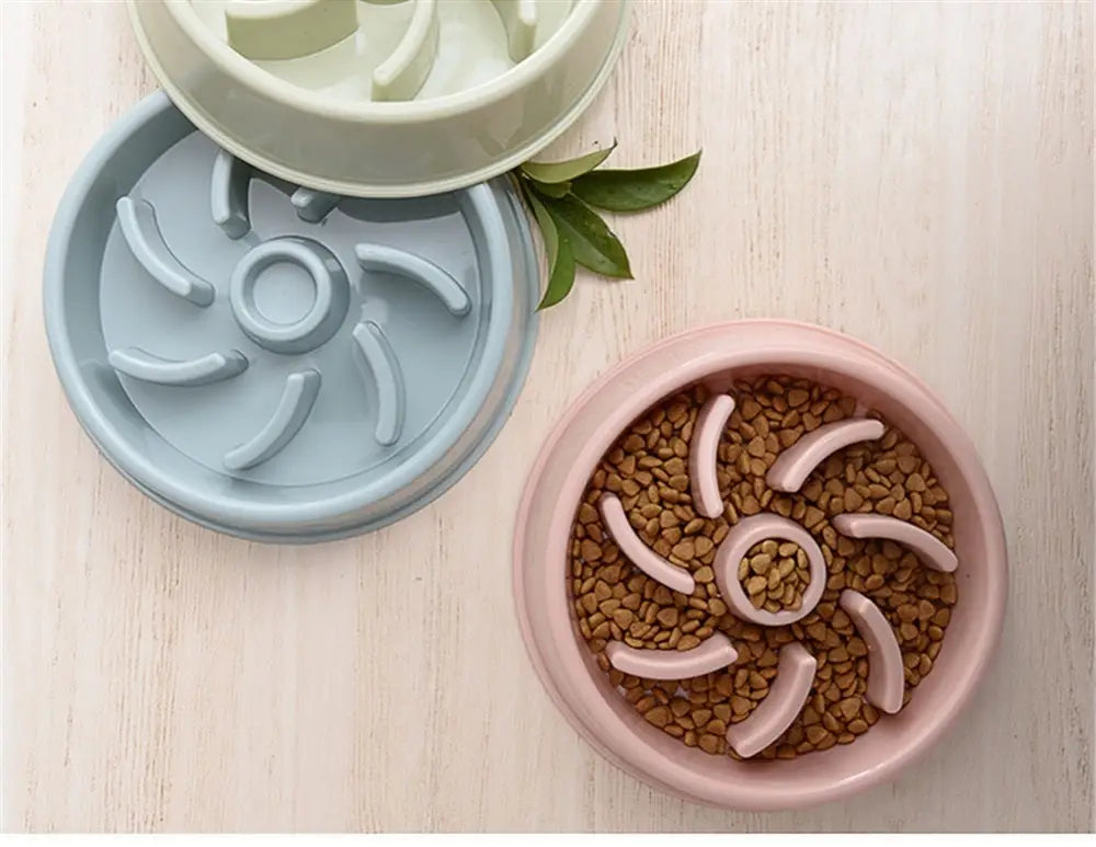 Pink silicone slow feeder dog bowl made of plastic with spiral-shaped feeding channels designed as an anti choke dish for pets.