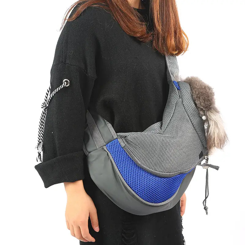 Breathable mesh pet carrier backpack in gray and blue mesh featuring a fluffy gray pom-pom accent.