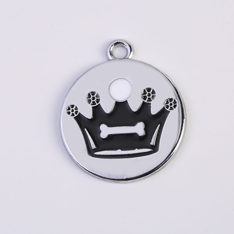 Silver circular pet ID tag featuring a black enamel crown with decorative spiked tips and a bone-shaped center from the crown enamel pet ID tag 5 pack.