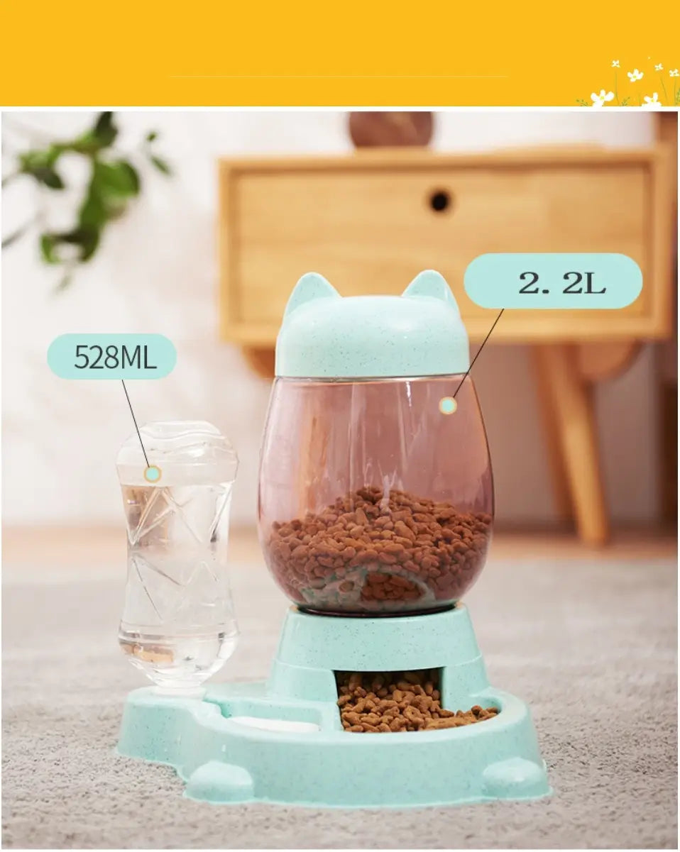 Light blue cat-shaped automatic cat feeder with a transparent body and 2.2 liter capacity featuring a matching base for kibble dispensing.