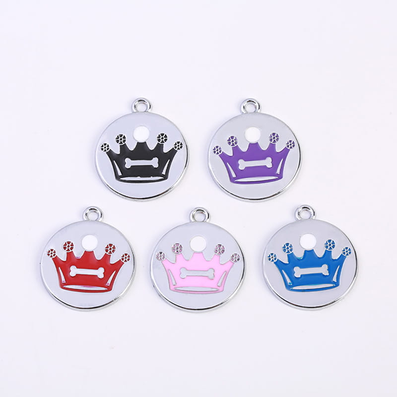 Five circular metal crown enamel pet id tags in black purple red pink and blue with engraved bone design in the center in a product titled Crown Enamel Pet Id Tag 5 Pack.