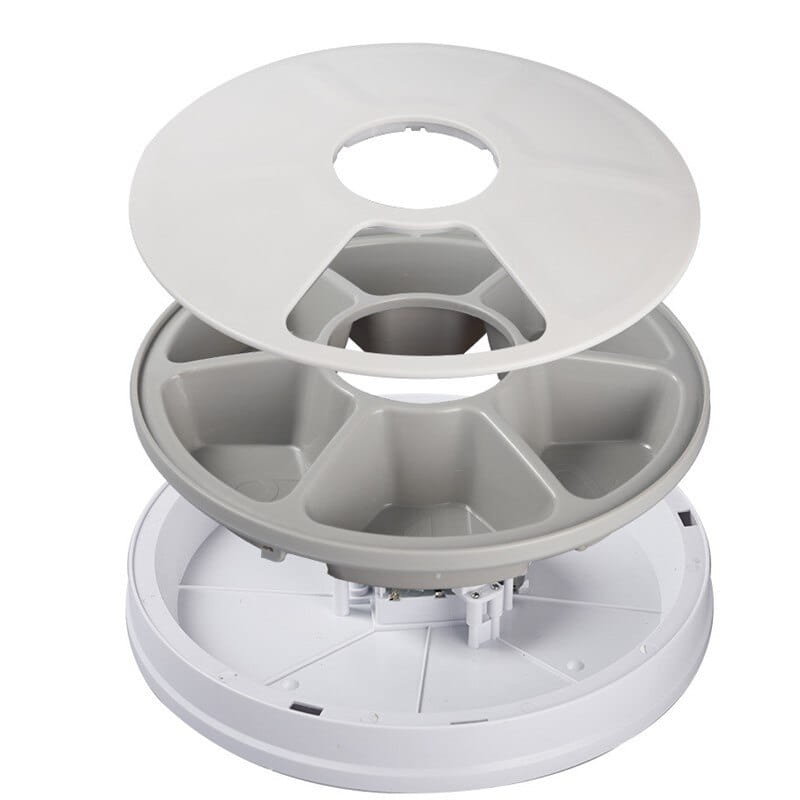 white plastic multi-compartment pill organizer with a circular design and segmented compartments for organizing pet medication in an automatic pet feeder 6 meal timing dispenser for dogs and cats.