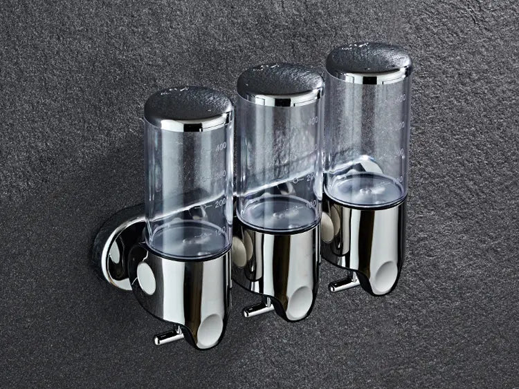 Wall mounted soap dispenser chrome ABS pump featuring a trio of transparent dispensers with measurement markings and chrome finish.