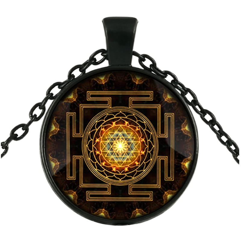 Black chain necklace featuring a circular glass cabochon pendant with an intricate golden sri yantra design on a dark background.