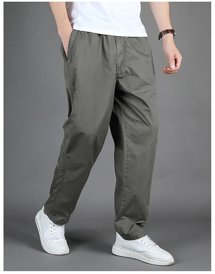 Olive green cotton chino men cargo pants with elastic waistband and side pockets designed for casual relaxed fit.