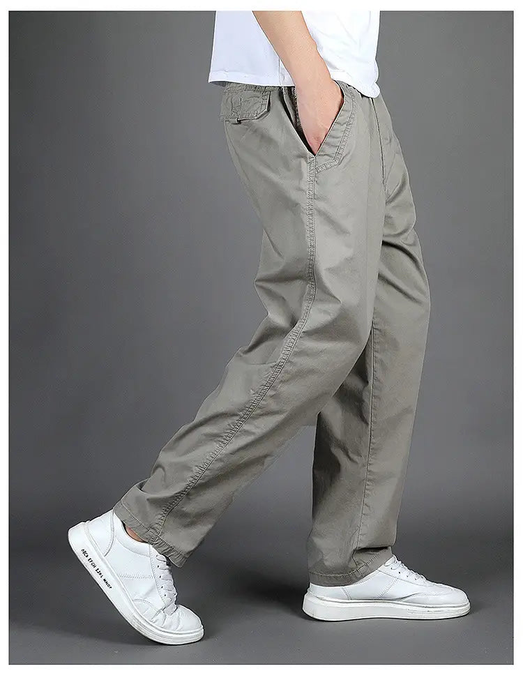 Khaki men cargo pants with multiple pockets elastic cuffs and relaxed fit made of cotton for casual use.