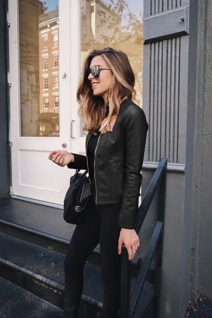 Black faux leather bomber jacket fitted with a front zipper and ribbed cuffs.