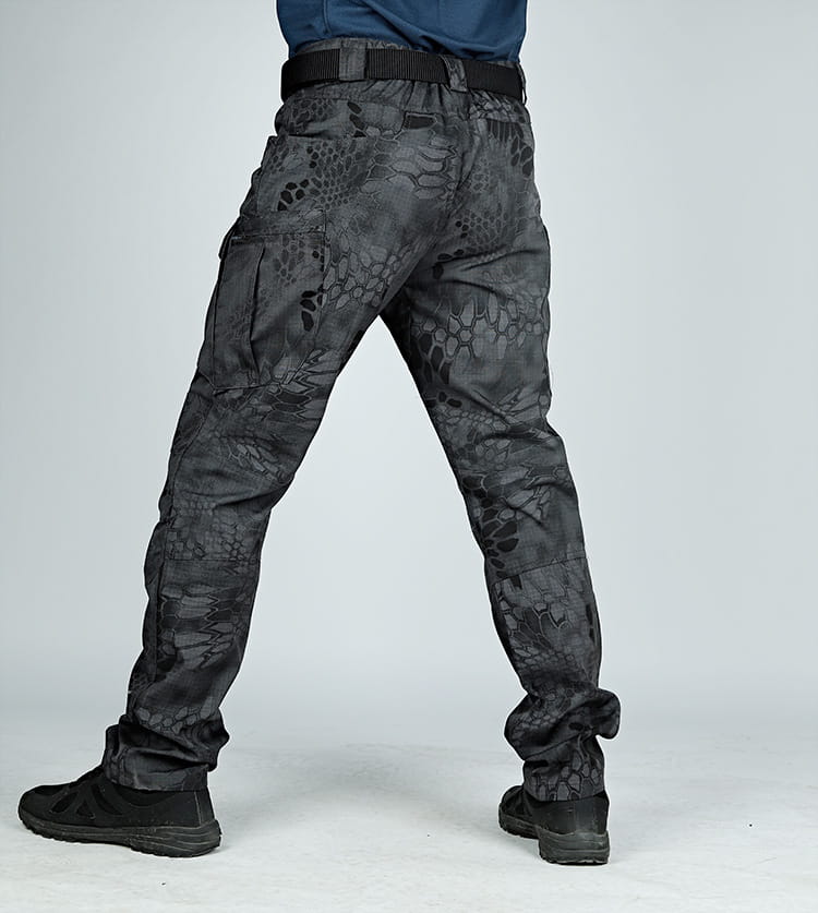 Ix7 men’s tactical cargo pants in black featuring a detailed snake-scale camouflage pattern and multiple cargo pockets designed for army training use.