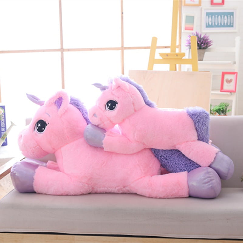 Pink plush unicorn stuffed toy with purple mane and hooves featuring starry eyes soft and cuddly stuffed animal.