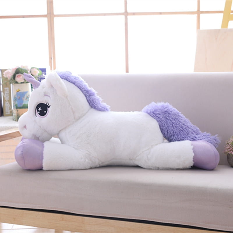 A plush white unicorn stuffed animal with lavender mane and tail featuring a soft fluffy texture in pink and purple hues.