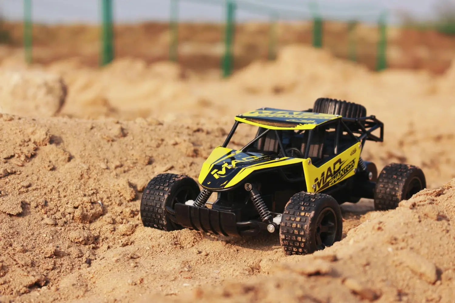 Yellow and black rc drift car mad phantom off-road buggy 2.4g with rugged tires and detailed chassis designed for off-road use.