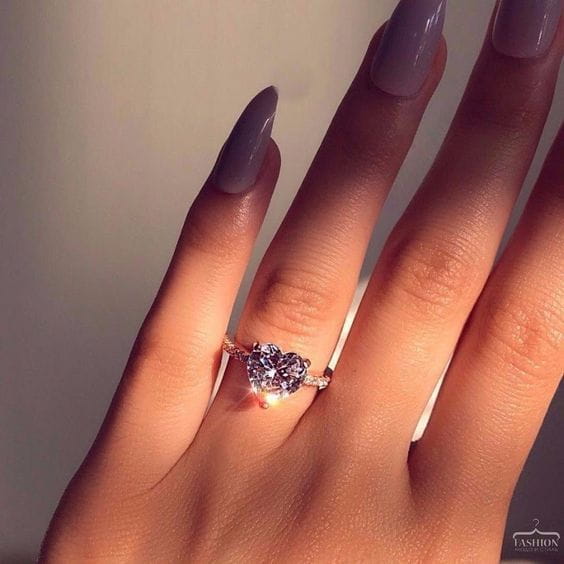 Heart shaped zircon engagement ring in white gold plating featuring a rose gold heart shaped band with a sparkling central stone.