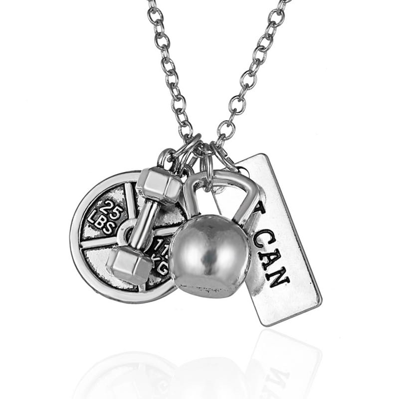 Silver-toned inspirational fitness pendant necklace featuring a chain with multiple gym-themed charms including a dumbbell kettlebell weight plate marked 25 lbs and a rectangular tag engraved with the word can.