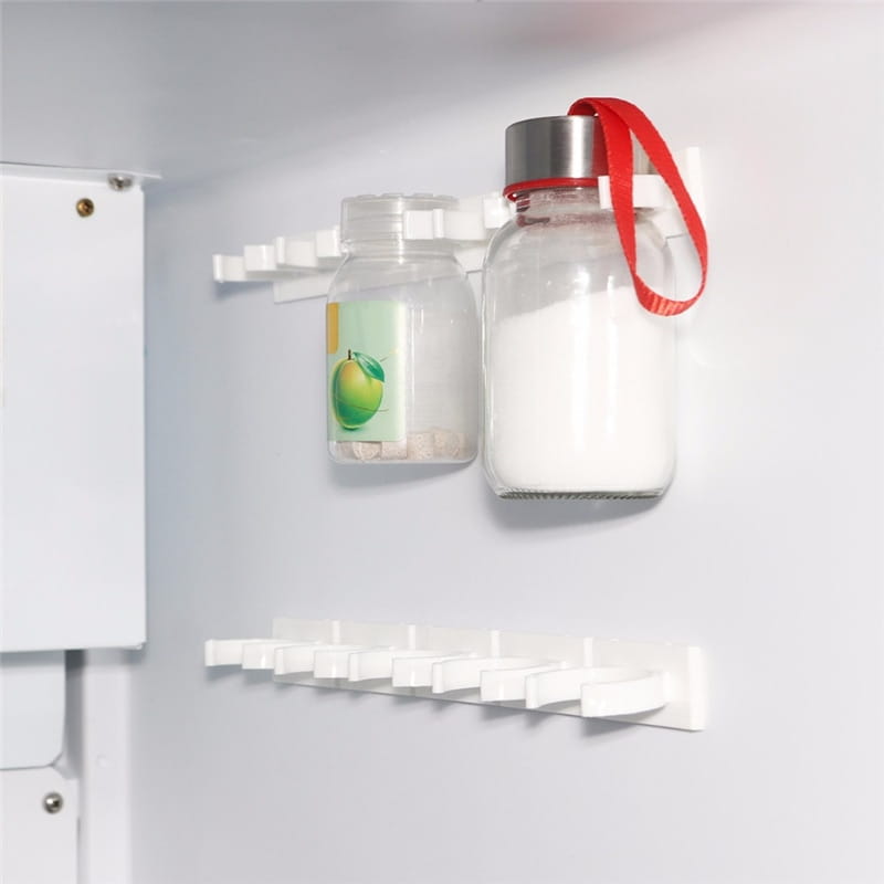 white plastic refrigerator wall organizer with adhesive clips and multiple slots holding two glass jars designed as a spice rack organizer wall mount.