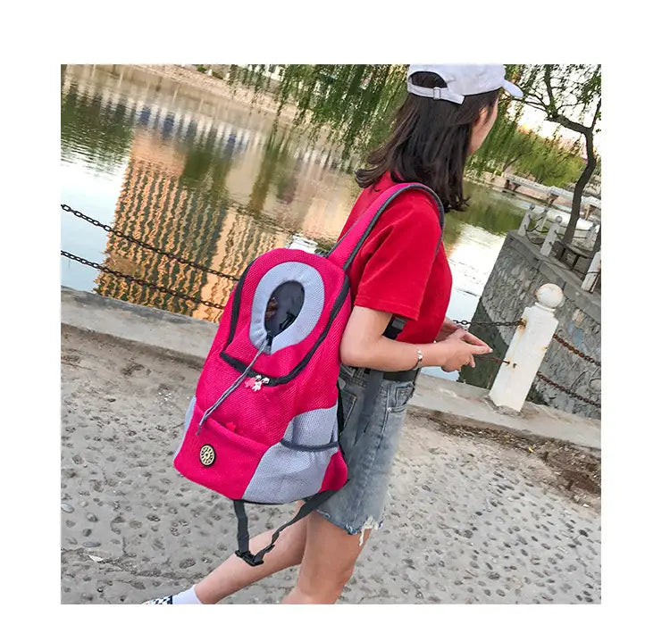 Pink and gray dog backpack breathable mesh pet carrier travel bag featuring mesh panels and a circular opening for the animal’s head.