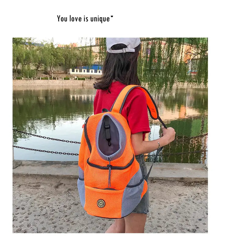 Bright orange and gray mesh dog backpack breathable mesh pet carrier travel bag with black trim.