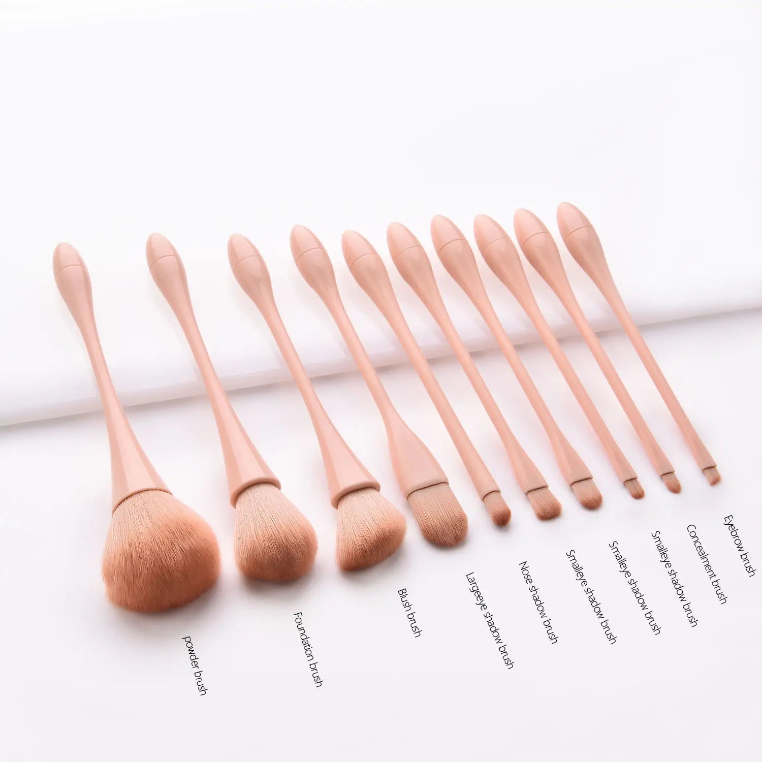 Set of ten professional nylon blush foundation and eye shadow brushes with rose gold handles and soft bristles in a pink makeup brush set 10pc.