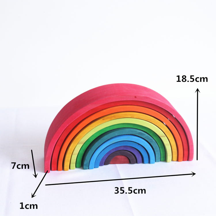 A colorful wooden rainbow stacking arch bridge puzzle toy with 12 smooth, rounded pieces in vibrant hues from red to violet.