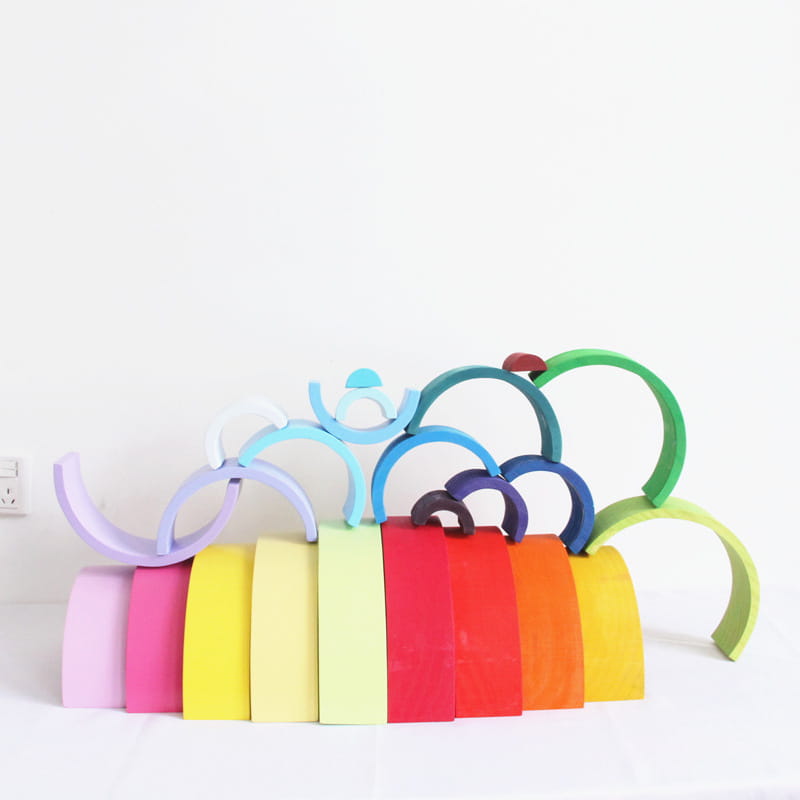 Rainbow wooden stacking arch bridge 12 piece puzzle toy featuring colorful wooden arches arranged in a playful stacked formation.