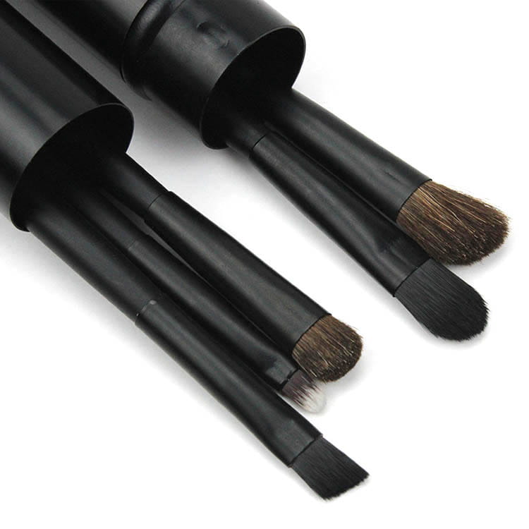 Travel eye makeup brush set featuring black natural bristle brushes with varying shapes housed in a matching portable cylindrical case.