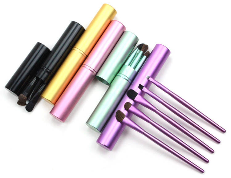 Set of colorful aluminum travel eye makeup brushes with matching portable cylindrical cases in black gold pink mint green and purple.