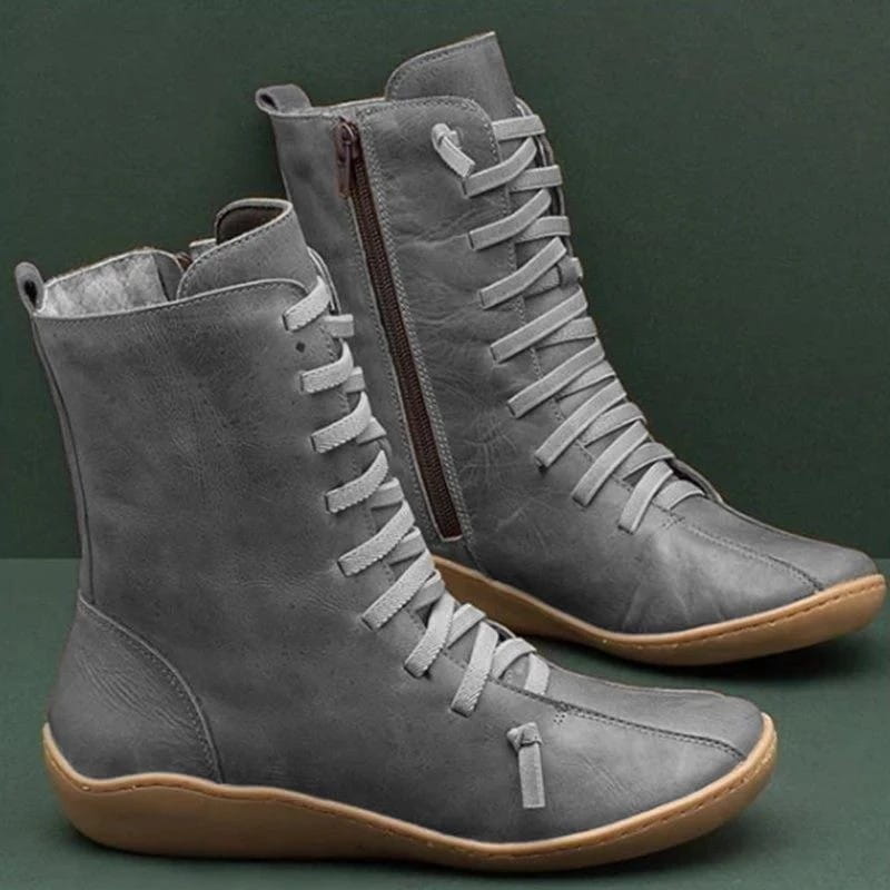 bottines Martin en daim gris, à lacets et fermeture éclair au niveau de la cheville, avec semelle en caoutchouc ambré et fermeture éclair sur le côté intérieur.