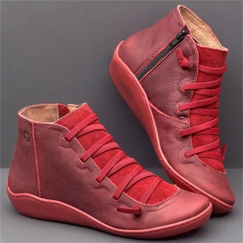 snake print wedge ankle boots for women featuring red suede high-top sneakers with matching laces and a zipper on the inner side.