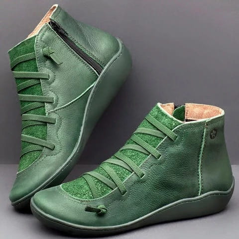 Green leather high-top sneakers with laces and a side zipper featured as part of the snake print wedge ankle boots for women collection.